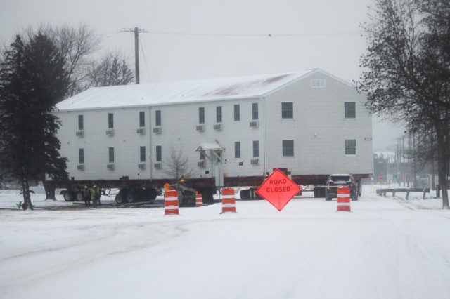 A barracks building from the 1600 block at Fort McCoy, Wis., is shown being moved Feb. 12, 2025, from the 1600 block to another area of the installation. Contractors are moving several buildings in January and February 2025. These buildings will...