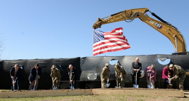 With the nation's colors flying from an excavator in the background, David Manka, chief of Army Corps of Engineers Construction Division; Mark Goodwin, Clark Construction senior vice president; Fort Leavenworth Garrison Command Sgt. Maj. Vanessa...