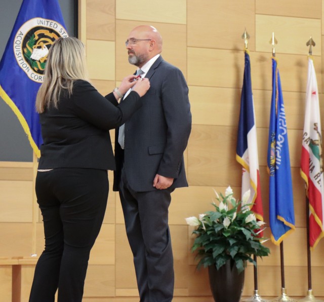 Outgoing Product Lead for Multi-Domain Sensing System Tom Bentzel receives the Meritorious Civilian Service Medal from Project Director Sensors-Aerial Intelligence Julie Isaac.