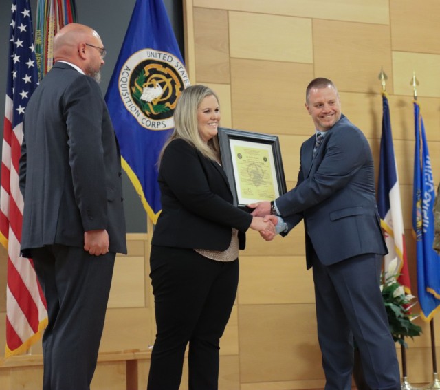 Eric Hughes (right) receives the Product Manager Multi-Domain Sensing System Charter from Project Director Sensors-Aerial Intelligence Julie Isaac