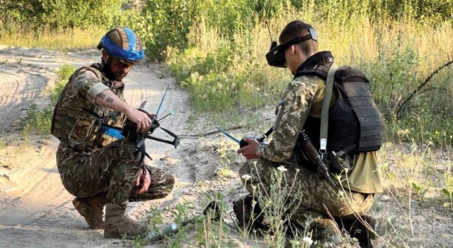 Ukrainian Soldiers from the 25th Sicheslavska Brigade prepare an improvised first-person view (FPV) strike drone.
