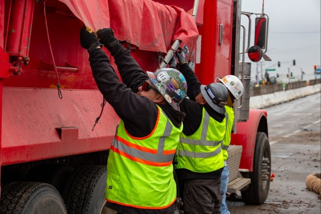 Fire Ash and Debris Gets Wrapped and Secured in Trucks