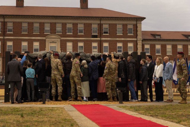 Members of Pfc. Roland L. Bragg’s family and distinguished guests unveil the new Headquarters XVIII Airborne Corps and Fort Bragg sign during the base redesignation ceremony on Fort Bragg, N.C., March 7, 2025. The redesignation of Fort Liberty...