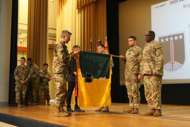 Lt. Gen. Matthew McFarlane, commanding general of America’s First Corps at Joint Base Lewis-McChord, adds the 2024 Army Emergency Relief Campaign streamer to the 1st Multi-Domain Task Force&#39;s flag March 26 during the 2025 AER Annual...