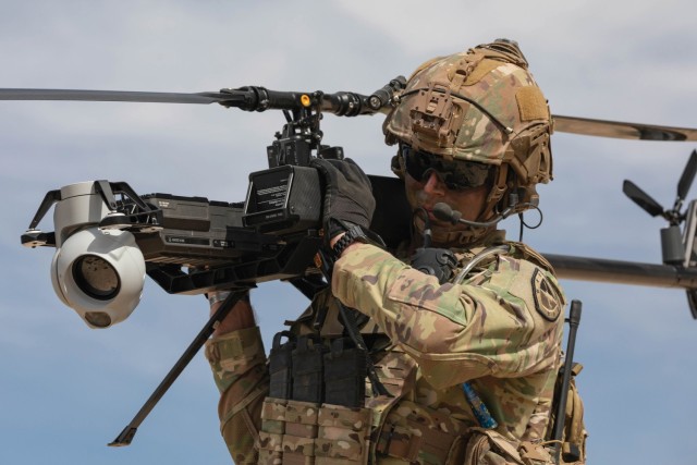 U.S. Army Staff Sgt. Stetson Manuel, an infantryman and Robotics and Autonomous Systems platoon sergeant from Alpha Company, 1st Battalion, 29th Infantry Regiment, 316th Cavalry Brigade, carries the Ghost-X Unmanned Aircraft System after its...