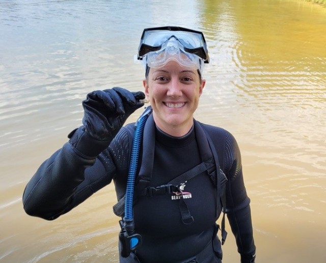 Christina McCree holds up a ring she found in Lake Tuscaloosa in September 2021