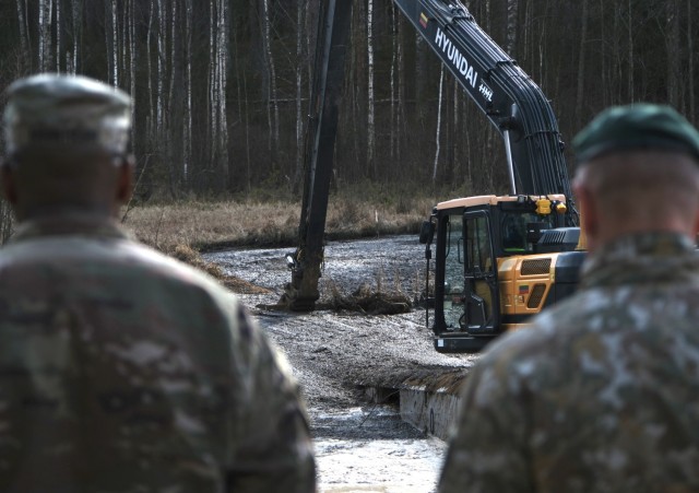 U.S. Army soldiers from the 1st Armored Brigade Combat Team, 3rd Infantry Division, Lithuanian Army and emergency services personnel discuss their plan during a challenging engineering task recovering a U.S. Army M88 Hercules submerged under...
