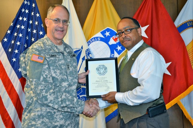 Former commander of the Security Assistance Command Maj. Gen. Del Turner recognizes Shawn Costley for 25 years of service to the federal government. Costley worked security assistance and foreign military sales for USASAC for ...