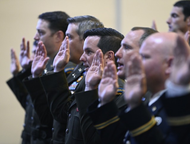 Warrant Officers from the U.S. Army John F. Kennedy Special Warfare Center and School take an oath of commission during the Special Forces Warrant Officer Technical and Tactical Certification Appointment and Graduation Ceremony at Fort Bragg,...