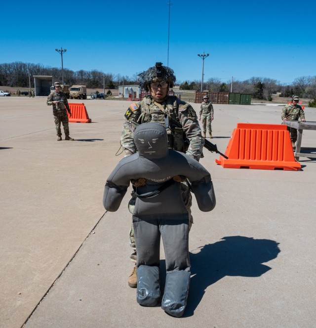 Staff Sgt. Richard Chavez, a member of the 3rd Chemical Brigade squad, drags a weight, simulating an injured person, to cover before shooting at a target during the Stress Shoot event of the Maneuver Support Center of Excellence 2025 Best Squad...