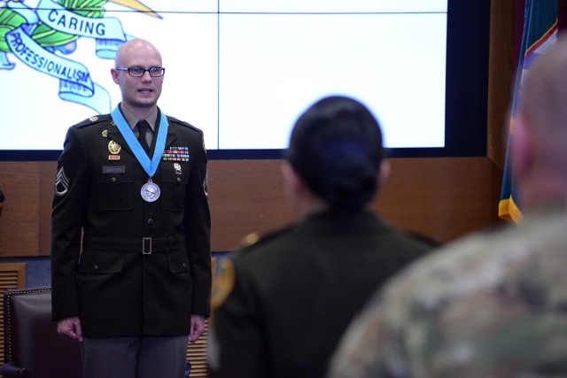 Staff Sgt. Quinlan Simpson, C Company, U.S. Disciplinary Barracks Battalion (Corrections), recites the NCO Creed with fellow NCOs during his Sergeant Audie Murphy Club induction ceremony March 28, 2025, in Grant Auditorium at Fort Leavenworth,...