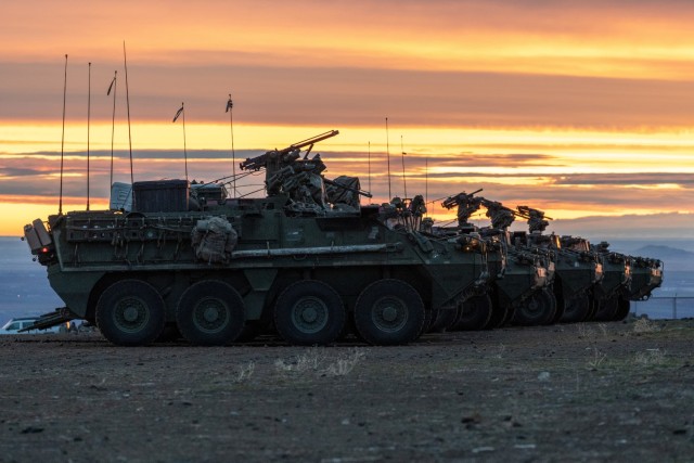 Strykers assigned to 2nd Stryker Brigade Combat Team park in a line before conducting a combined arms blank-fire exercise during exercise Rising Thunder on December 10, 2021 at Yakima Training Center, Wa.