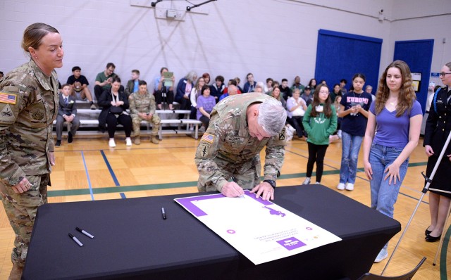 Fort Leavenworth Garrison Command Sgt. Maj. Vanessa Sun and Fort Leavenworth Garrison Commander Col. Duane Mosier, followed by Harrold Youth Center representatives Maddy Genge and Alexis Hoffman and Osage School-Age Center representatives Olivia...