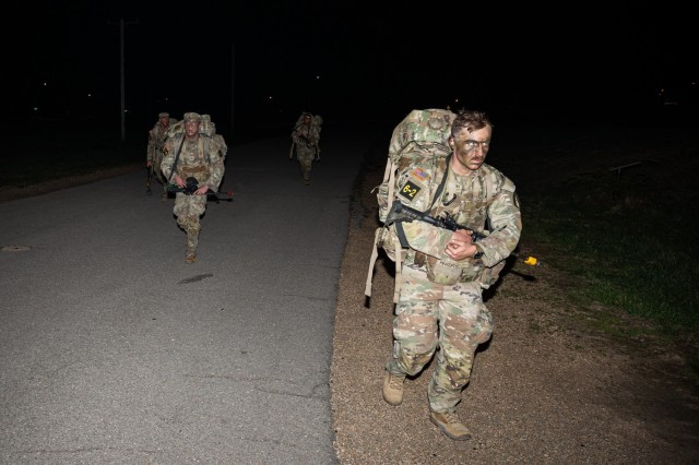 Maneuver Support Center of Excellence 2025 Best Squad competitors reach the final stretch of a 6-mile road march event March 27 on Fort Leonard Wood’s Troop Trail near Abrams Theater.