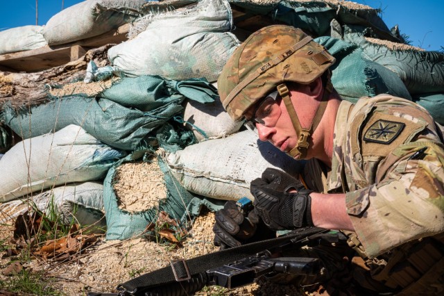 Pvt. Brennan Maykopet, a member of the 14th Military Police Brigade squad, prepares to throw a grenade into a bunker during the Expert Soldier Badge Round Robin event of the Maneuver Support Center of Excellence 2025 Best Squad Competition March...