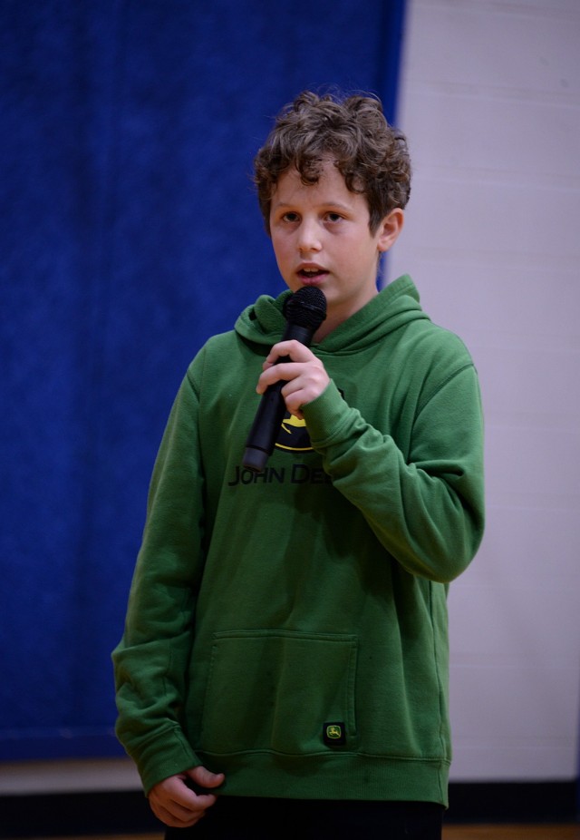 Twelve-year-old Benjamin Shumaker, sixth-grader at Patton Junior High School, sings the national anthem for the Month of the Military Child kickoff ceremony April 1, 2025, at Harrold Youth Center at Fort Leavenworth, Kansas. He said he was asked...