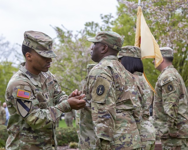 Battalion Command Sergeant Major Command Sgt. Maj. Reginald Smith places the new Military District of Washington patch on the shoulder of Sgt. 1st Class Andre Williams, the battalion&#39;s operation sergeant during a patching ceremony April 3 at...