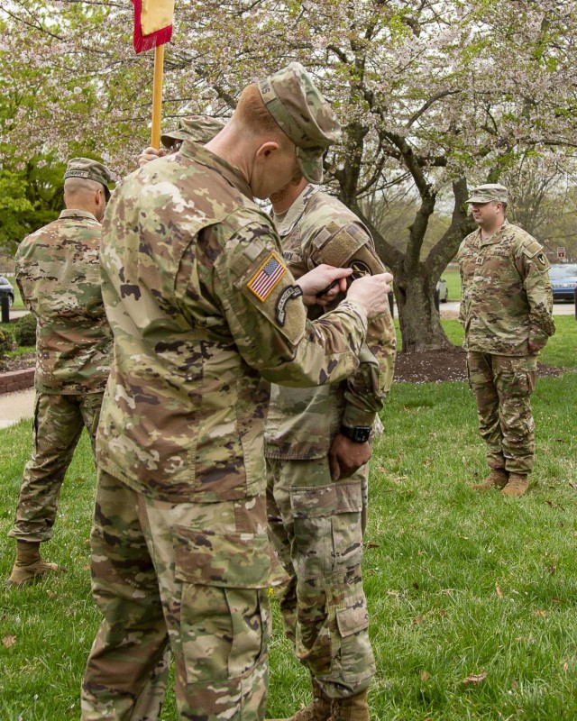 Garrison Command Sergeant Major Command Sgt. Maj. Daniel Hopkins places the Military District of Washington patch on Headquarters Command Sergeant Major Command Sgt. Maj. Reginald Smith during a patching ceremony at Fort Belvoir, April 3, at...