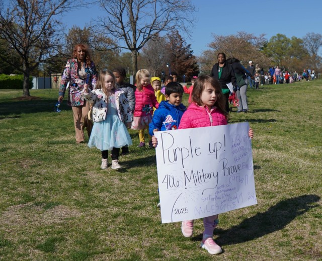Children march around the Cody Child Development Center Apr. 1 during the Pinwheel Ceremony to kick off Month of the Military Child.