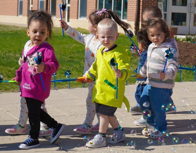 Children march around the Cody Child Development Center Apr. 1 during the Pinwheel Ceremony to kick off Month of the Military Child.