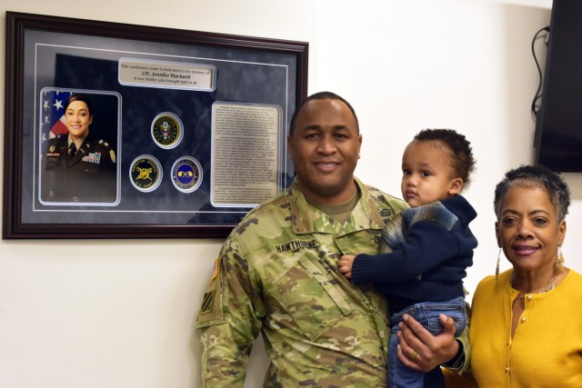 From left, U.S. Army Capt. Jamel Hawthorne, husband of Lt. Col. Jennifer Blackwell-Hawthorne, their son Jamel Jr. (JJ), and Blackwell-Hawthorne’s mother, Gaye Blackwell-Taylor, stand by a newly unveiled plaque in honor of Blackwell-Hawthorne at...
