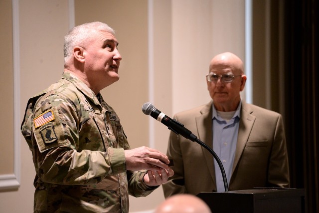 Chaplain (Col.) Sean Wead, Combined Arms Center and Fort Leavenworth senior chaplain, thanks guest speaker retired Maj. Gen. Gregg Martin for his message with a compass, symbolizing the connection between Fort Leavenworth and the Lewis and Clark...