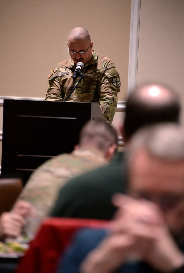 Fort Leavenworth National Prayer Luncheon attendees bow their heads as Chaplain (Capt.) Michael Shipma, Midwest Joint Regional Corrections Facility Battalion (Corrections) facility chaplain, says a prayer for the nation April 3, 2025, at the...