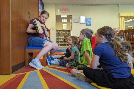 Maribel Sikes hosts a story time for children at Camp Zama, Japan. Sikes, the daughter of Lt. Col. Nick Sikes, is the 2025 Operation Homefront Military Child of the Year.