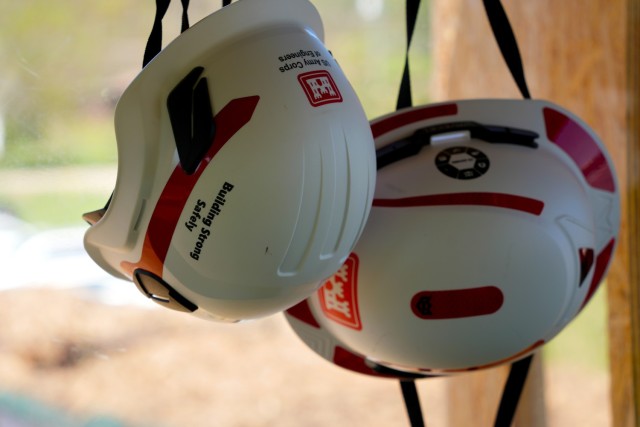Two hard hats hang on a wall inside the U.S. Army Corps of Engineers’ debris load inspection tower at the Old Fort Debris Management Site in Old Fort, North Carolina, April 9, 2025. Corps staff stationed here oversee the debris tracking and...