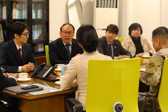 Senior leaders in contracting participating in tea ceremony.