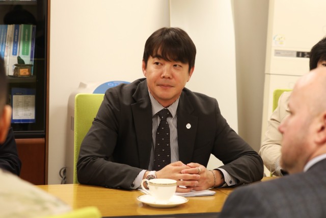 Senior leaders in contracting participating in tea ceremony.