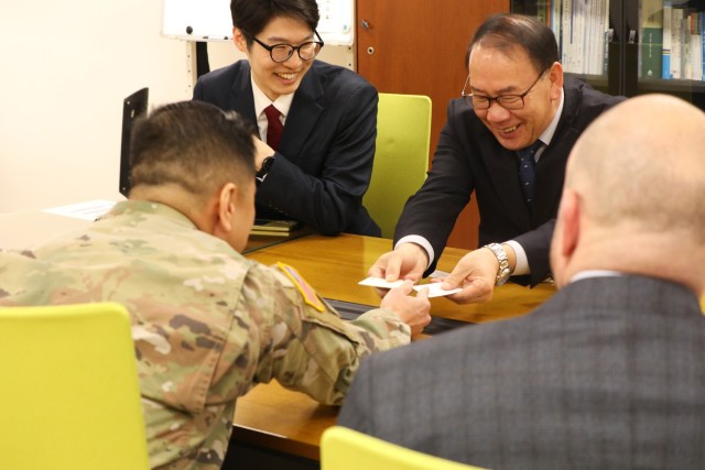 Senior leaders in contracting participating in tea ceremony.