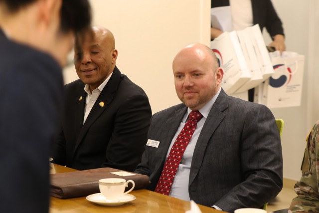 Senior leaders in contracting participating in tea ceremony.