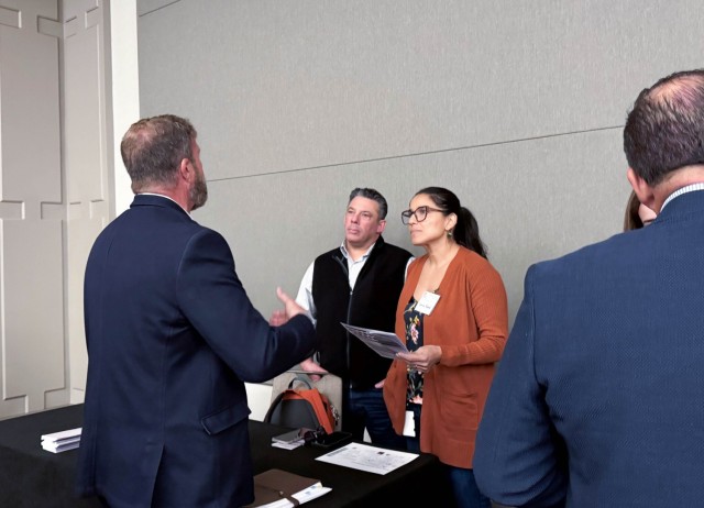 U.S. Army Corps of Engineers Sacramento District team members, Josh Garcia (left) and Larissa Boland (right) speak to an attendee at the annual Business Opportunity Open House hosted by the small business section at the Hyatt Regency in...