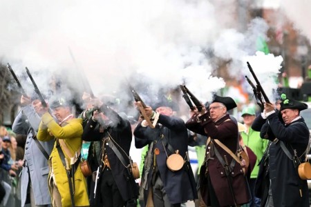The Lexington Militia Men perform a musket firing demonstration during Boston's St. Patrick's Day parade March 16, 2025 (Photo by Joe Farrar).