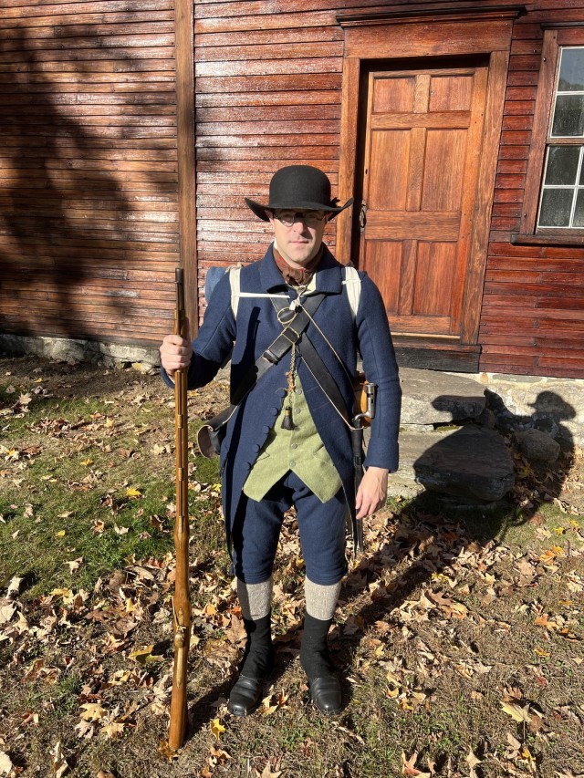 Army Reserve Sgt. James Doucette, a Heating, Ventilation and Air Conditioning mechanic at Fort Devens, Massachusetts, wears his Lexington Minute Men militia kit outside the Hartwell Tavern at the Minuteman National Historical Park during a 250th...