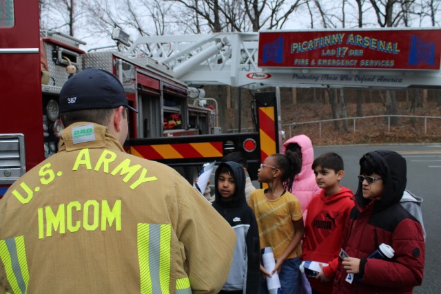 ROCKAWAY, N.J. - A firefighter with the Picatinny Arsenal Fire Department discusses firefighting and rescue operations with students.