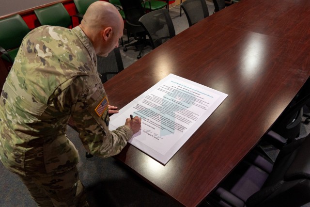 Col. Gregory Holmes and Command Sgt. Maj. Douglas Jones, the U.S. Army Security Assistance Training Management Organization command team, sign a proclamation declaring April as Sexual Assault Awareness and Prevention Month at Fort Bragg, N.C.,...