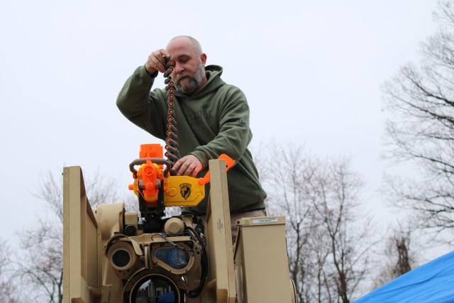 ROCKAWAY, N.J. - Chris Greenley, Mechanical Engineering Technician with U.S. Army Combat Capabilities Development Command Armaments Center, atop a High Mobility Multipurpose Wheeled Vehicle (HMMWV) with mounted Common Remotely Operated Weapon...