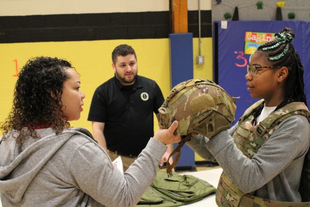 ROCKAWAY, N.J. - Colin Summerville, a general engineer assigned to the U.S. Army Combat Capabilities Development Command Armaments Center, shows students some of the protective gear that Soldiers wear.