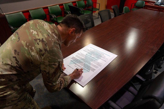 Col. Gregory Holmes and Command Sgt. Maj. Douglas Jones, the U.S. Army Security Assistance Training Management Organization command team, sign a proclamation declaring April as Sexual Assault Awareness and Prevention Month at Fort Bragg, N.C.,...