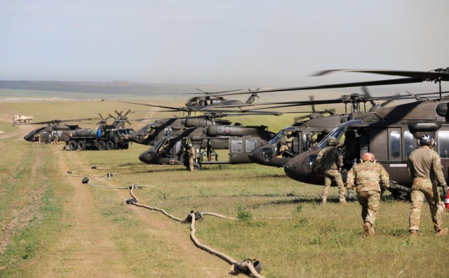 Petroleum supply specialists with the 3rd Attack Helicopter Battalion, 1st Aviation Regiment refuel UH-60 Black Hawks during a multinational air assault exercise with the Dutch 11th Air Assault Brigade here May 14. Large-scale movement of troops...