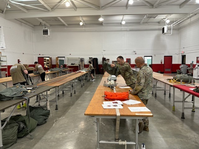 ADRST NCOIC SFC Runyan and SFC Monje from the 403rd QM RST conduct a QAQC on a T-11 Reserve at their unit’s newly established rigging facility located in Roseboro, NC. The rigging facility was recently established after conducting rigging...