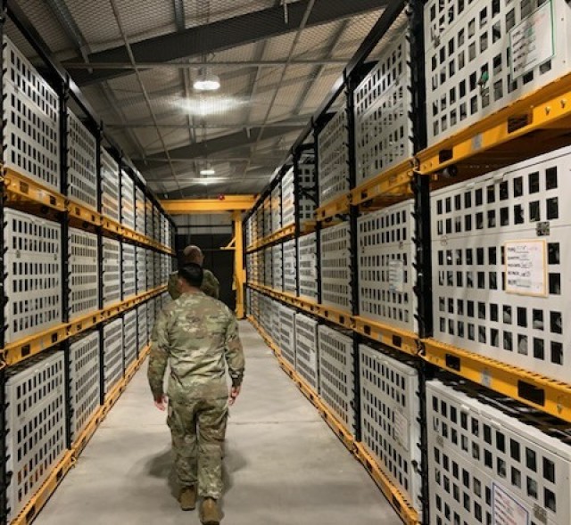 Previous ADRST Director CW5 Ramosbarbosa inspects the Ready for Issue cage located at JRTC’s Rigger Detachment, Fort Johnson, LA. Their rigging facility is one of the few rigging facilities designed with automated rails for ease of use during...