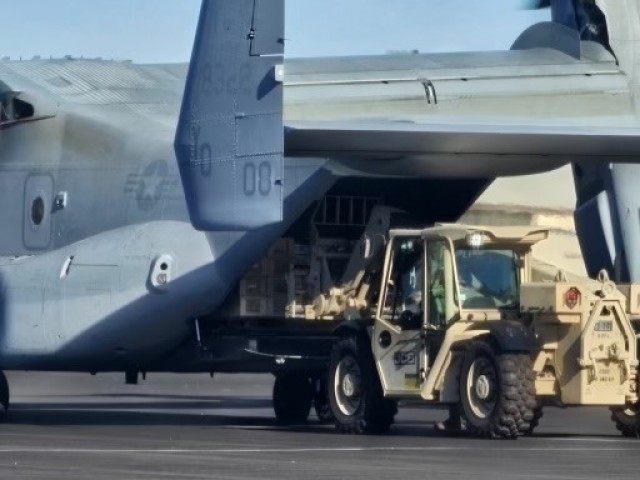 A 5k forklift working jointly with a USMC Osprey to deliver CLIX to Pohakukoa Training Area from Wheeler Airfield in support of OPFOR operation for JPMRC 24, Wheeler Airfield, Oct. 18, 2023.