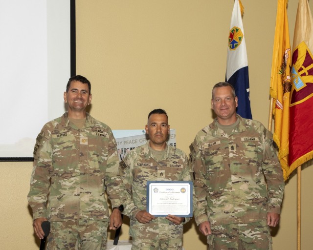 (from left to right) U.S. Army Maj. Shawn M. Blaydes, senior civil affairs Observer Controller/Trainer with Ghost Team, Operations Group, National Training Center, Staff Sgt. Johnny P. Rodriguez, active-duty operational support Soldier with Ghost...