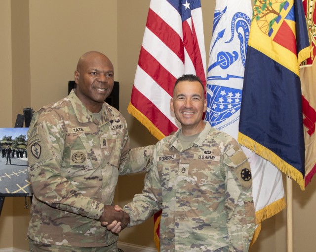 U.S. Army Command Sgt. Maj. Carvet C. Tate, Command Sgt. Maj. of National Training Center and Fort Irwin shakes the hand of Staff Sgt. Johnny P. Rodriguez, active-duty operational support Soldier with Ghost Team, Operations Group, Rodriguez, a...