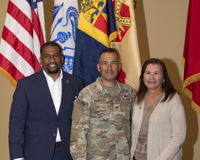 U.S. Army Staff Sgt. Johnny P. Rodriguez, active-duty operational support Soldier with Ghost Team, Operations Group, Rodriguez, a reservist from the U.S. Army Civil Affairs and Psychological Operations Command, stands with his mother and retired...