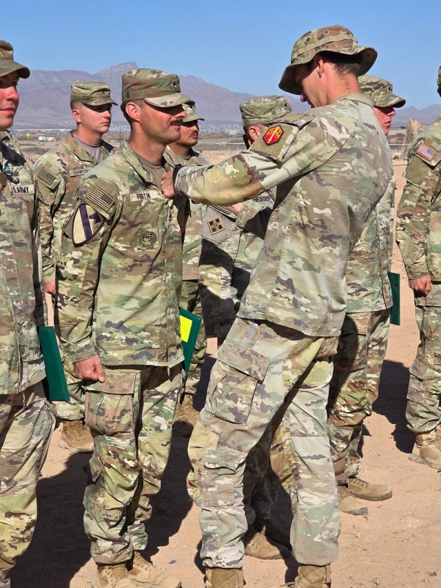 Sgt. 1st Class Jarrett L. Fortin (center)