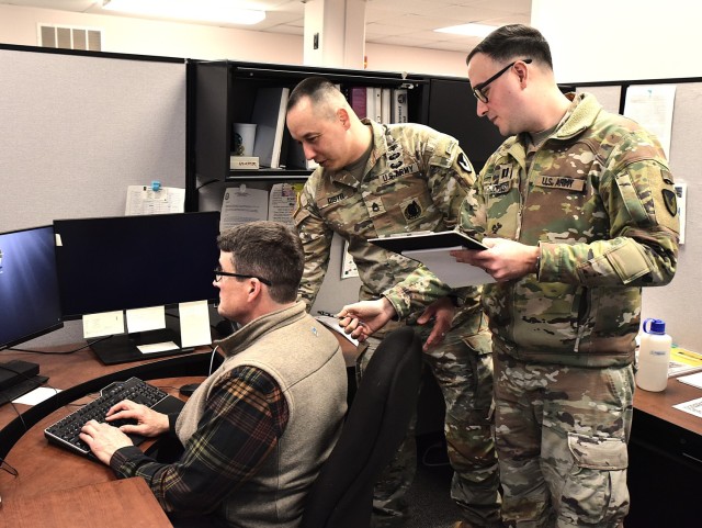 Capt. Timothy Johnson (right) and Sgt. 1st Class Fidel Distel conduct an ergonomics assessment on Carter Meredith March 31. All three work in the Office of Command Surgeon, U.S. Army Sustainment Command, Rock Island Arsenal, Illinois. An ergonomic...